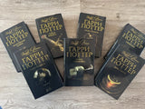 Collection of 'Harry Potter' books black edition collectible on a wooden surface
