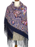 Blanket size woolen palatine scarf with purple paisley patterns and fringes on a mannequin against a white background