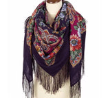 Colorful dark purple scarf with terracotta flowers with fringes on a mannequin against a white background