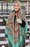 Woman wearing a patterned scarf in a snowy outdoor setting