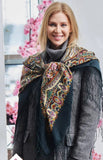 Very big shawl on woman shoulders with silky fringe and 100% wool fabric.