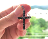 Silver and marcasite small cross in a hand