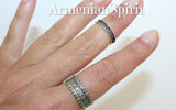 Two knuckle rings on a woman hand with delicate floral ornaments made of silver 925.