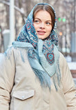 Woman wearing a patterned sky blue scarf outdoors in winter