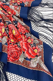 Floral patterned navy shawl with red flowers on a blue background.