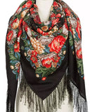 This oversized black shawl features a classic Slavic floral design with bold red and yellow peonies. Made from natural merino wool, its vintage charm is enhanced by a delicate silky fringe and generous wrap size.