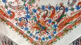 Colorful paisley patterned Slavic shawl with intricate designs on a white background