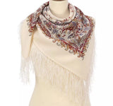 Slavic woolen traditional neck scarf with paisley pattern and fringes on a mannequin against a white background