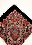 Decorative scarf with intricate paisley pattern on a black background