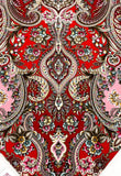 Decorative shawl with intricate paisley pattern on a red background