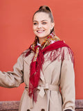 This fringed Slavic shawl is made of 100% merino wool from natural sheep wool. Worn by a woman, it glows with traditional charm through yellow and pink peony flowers on red.