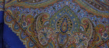 Close-up of a colorful paisley patterned blue shawl with fringe