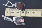 Defy convention with our handmade sterling silver 925 tiger's eye earrings from Armenia! Each piece features a unique, brown stripped gemstone, adding a touch of adventurous style to your look. A one of a kind, artisan creation perfect for risk-takers.
