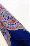 Blue patterned blue woolen scarf with tassels on a white background