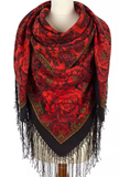 Red floral patterned scarf with black and gold accents on a mannequin against a white background