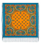 Close-up view of a square multicolored Slavic scarf, highlighting the vivid orange hood, the bright blue floral fabric, and the delicate woven fringe.