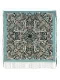 Paisley patterned throw shawl with fringes on a light blue background. Elegant and simple, this large green scarf features teal and black paisley ornaments inspired by traditional ethnic art. A beautiful piece for a calm, polished style.