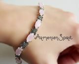 Pink beaded bracelet on a wrist with 'Armenian Spirit' text. Vintage-style silver link bracelet featuring pastel pink stones and sparkling marcasite X-links.