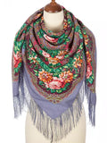 The wrapping shawl features pink and beige flowers blooming on elegant blue-gray colors.