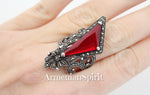 This ring is not for the faint of heart; it's a bold declaration of vintage style and a captivating nod to medieval aesthetics. The large red stone, the centerpiece of this piece, is undeniably eye-catching. Its rich color immediately draws the gaze, lending a sense of drama and perhaps even a touch of mystique. The stone reminds a royal ruby.