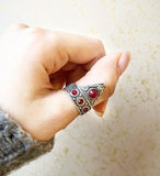 Armenian triangle thumb ring with gemstones and ornament.