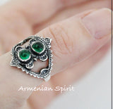 Expertly crafted by skilled artisans, this Sterling Silver 925 thumb ring boasts a traditional Eastern Armenian ornament embellished with vibrant green stones. Handmade and inspired by Western Armenian jewelry, it adds a touch of cultural elegance to any outfit. Perfect for those seeking unique and meaningful pieces.
