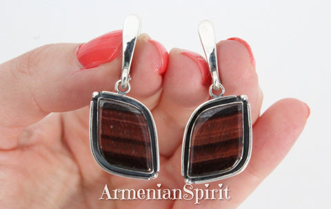 Unleash your inner daring with these artisanal, one-of-a-kind eye-shaped earrings. Handmade by skilled Armenian craftsman, each piece features a striking tiger's eye gemstone, perfect for adding a touch of boldness to any outfit. Elevate your style with high quality sterling silver 925 jewelry.
