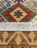 Close-up of a patterned Armenian rug with geometric design and white fringe.