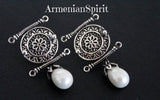 A pair of Armenian jewelry earrings featuring a round design with a drop lab pearl, crafted from oxidized sterling silver.