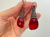 Indulge in a touch of luxury with our beautiful extra long earrings featuring a stunning transparent red stone and sparkling marcasite. Made from high quality sterling silver 925, these classic earrings will elevate your style and shine at any occasion, from parties to the Monaco France riviera. Purchase online at Armenian Spirit jewelry store.
