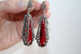 Handmade sterling silver statement set featuring an extra-large ring and elongated dangle earrings. The vibrant, clear red stones are beautifully highlighted by rows of shiny marcasites and dark oxidized silver detailing. A true masterpiece of traditional craftsmanship and regal design.
