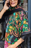 Woman wearing a colorful vintage peony floral and paisley patterned shawl on a street.