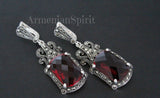 A pair of sterling silver long earrings featuring dark red stones and Marcasite accents, with vintage old style designs at the top.