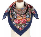 Colorful vintage peony floral and paisley patterned merino wool scarf on a mannequin with a white background