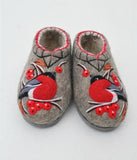 Pair of woolen wide slippers with red bird and berry design on a light gray background