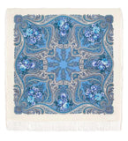 Square merino wool shawl palatine with blue floral paisley pattern on a beige background. Soft and elegant, this square shawl in milky white is decorated with light blue flowers.