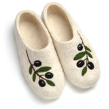 A pair of cream-colored felted wool slippers decorated with embroidered olive branches featuring green leaves and black olives, shown on a white background.