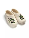 white slippers made from wool natural felt with black olives deign on a white background.