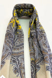 Herbal patterned women`s scarf made of cashmere like merino wool with yellow accents on a white background