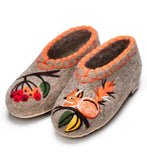Pair of woolen slippers with squirrel and berry design on a white background