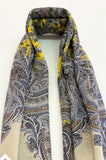 Herbal patterned women`s scarf with yellow accents on a white background