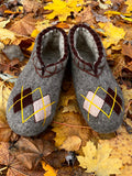 Large sized men woolen slip on slippers made from merino wool on autumn leaves in yellow and brown.