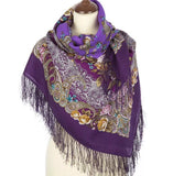 Purple women`s cashmere like scarf with peony and paisley patterns and fringes on a mannequin against a white background