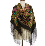 Colorful vintage floral-patterned black scarf made of high quality non prickly  merino wool like cashmere with silky fringe on a mannequin against a white background