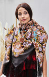 This authentic merino wool shawl in rich chocolate brown tones is worn by a woman with effortless grace. Beige and navy blue ornaments blend with floral patterns, while the silky fringe adds softness and movement. A warm, luxurious accessory rooted in Slavic tradition.