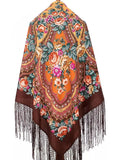Colorful floral-patterned brown shawl with silky long fringes. The shawl is made of merino wool. 