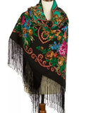 Colorful vintage Slavic scarf with field flowers patterns and black fringes on a mannequin against a white background.