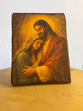 Handcrafted wooden icon of Jesus Christ embracing and comforting the Virgin Mary.