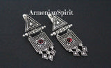A set of sterling silver 925 jewelry, including earrings and a ring with a red stone, displayed against a dark background with the text 'ArmenianSpirit' visible.