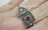 A set of sterling silver 925 jewelry, including earrings and a ring with a red stone, displayed against a dark background with the text 'ArmenianSpirit' visible.